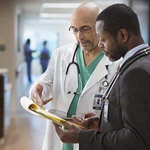 Doctor and administrator talking in hospital.